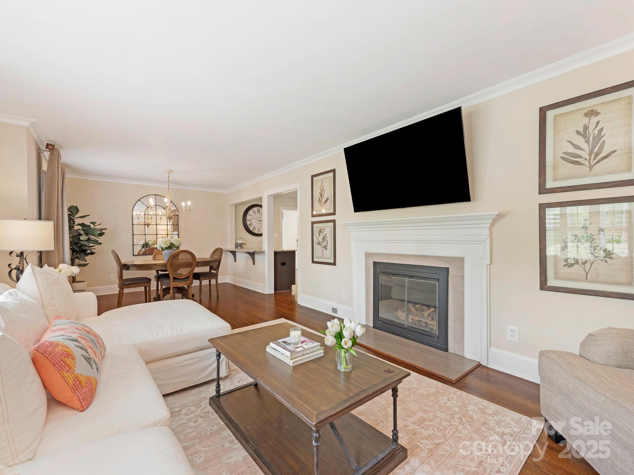 4346 Walker Road Charlotte, NC 28211 - Photo 4 of 30 a living room with furniture a fireplace and a flat screen tv