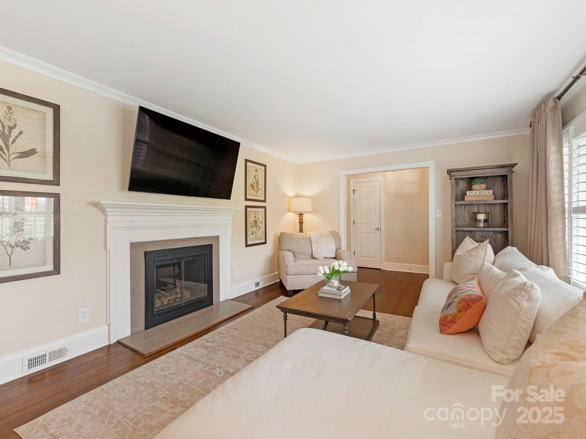 4346 Walker Road Charlotte, NC 28211 - Photo 7 of 30 a living room with furniture a flat screen tv and a fireplace