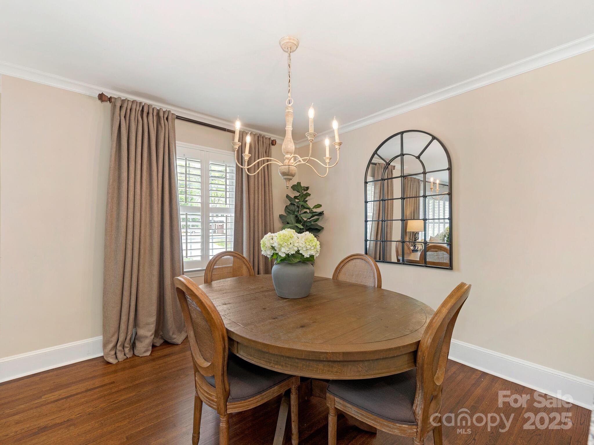 4346 Walker Road Charlotte, NC 28211 - Photo 8 of 30 a dining room with furniture potted plants and wooden floor