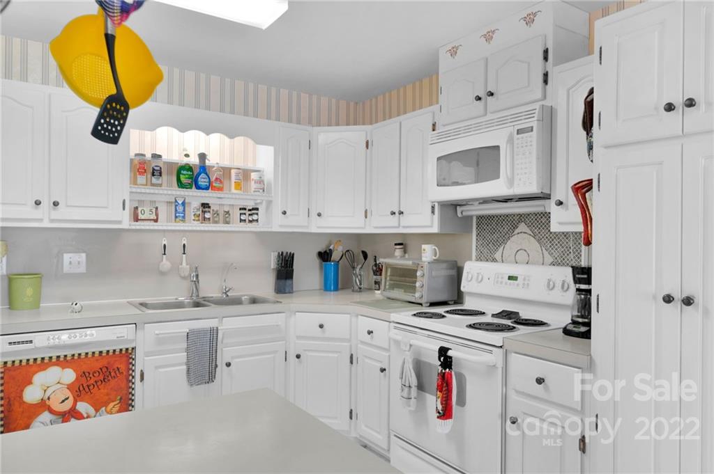 1414 Lighthouse Avenue Fort Mill, SC 29708 - Photo 13 of 47 a kitchen with stainless steel appliances granite countertop a sink a stove and cabinets