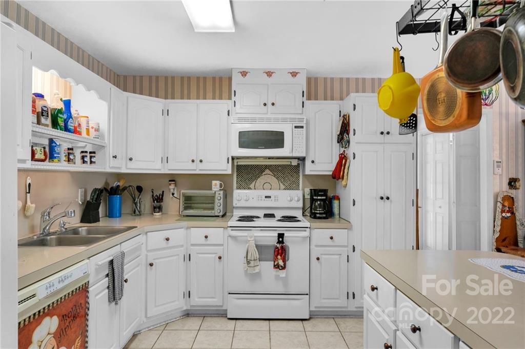 1414 Lighthouse Avenue Fort Mill, SC 29708 - Photo 14 of 47 a kitchen with stainless steel appliances granite countertop a stove a sink and a white cabinets