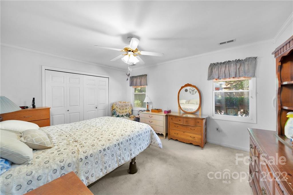 1414 Lighthouse Avenue Fort Mill, SC 29708 - Photo 19 of 47 a bedroom with a large bed and a chandelier