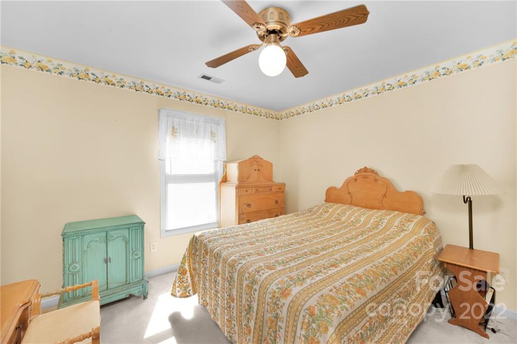 1414 Lighthouse Avenue Fort Mill, SC 29708 - Photo 20 of 47 a bedroom with a bed and a chandelier