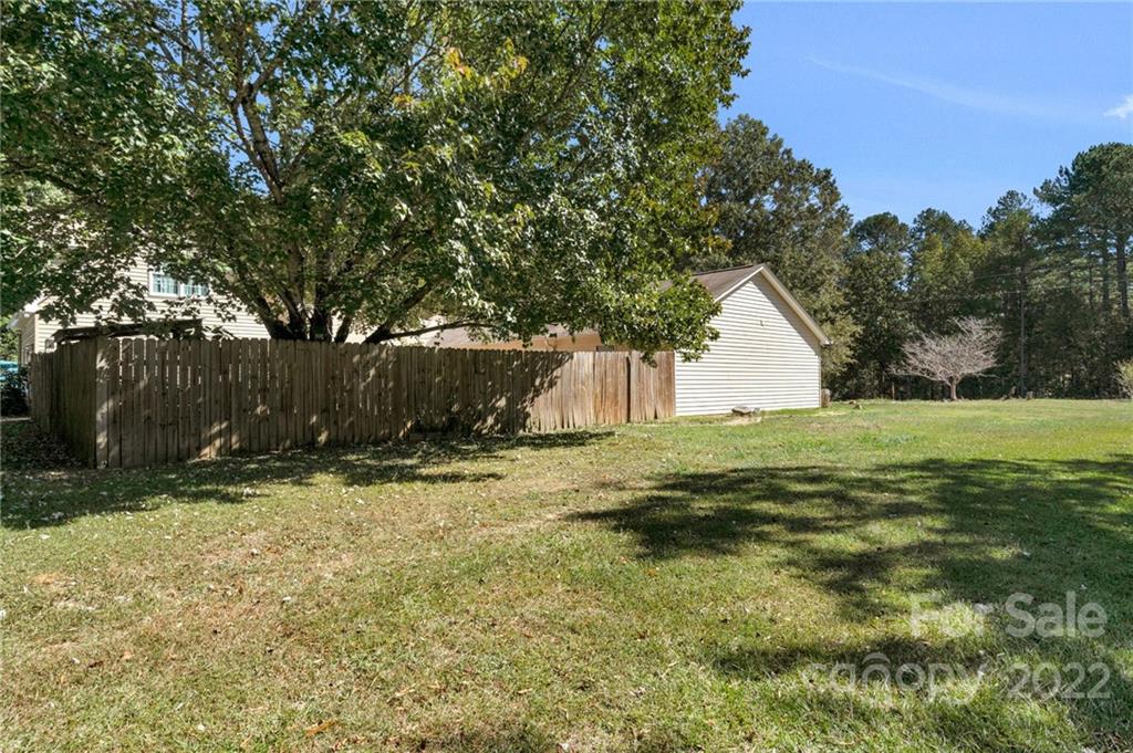 1414 Lighthouse Avenue Fort Mill, SC 29708 - Photo 46 of 47 a view of backyard with wooden fence and a large tree