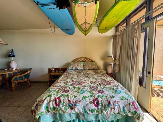 a bedroom with a bed and a painting on the wall