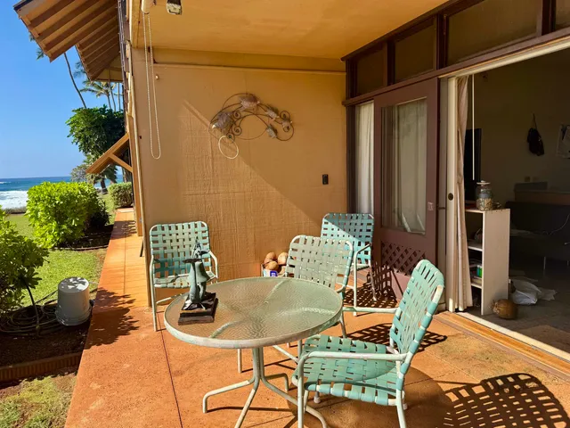 a view of a balcony dining table and chairs