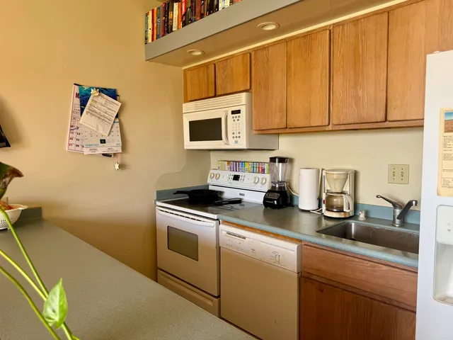 a kitchen with stainless steel appliances granite countertop a sink and cabinets