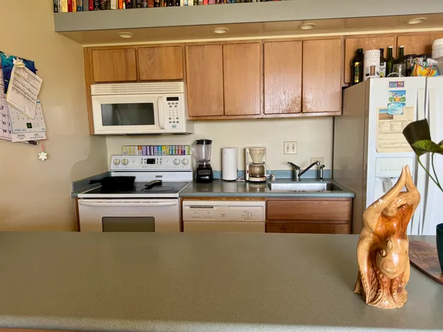 a kitchen with stainless steel appliances a stove a microwave and cabinets