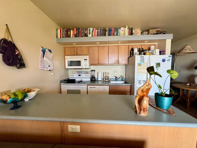 a view of a living room with furniture and a wooden floor