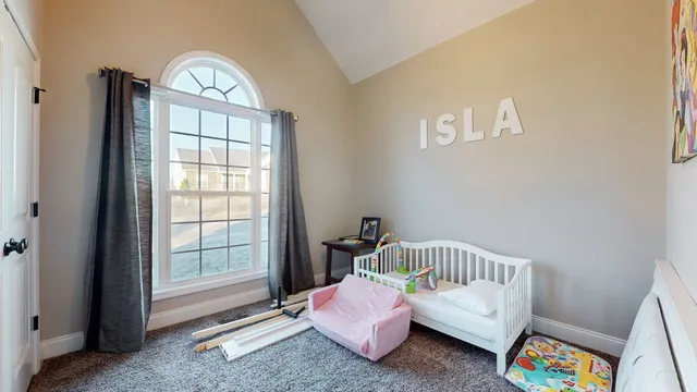 a bedroom with furniture and a window