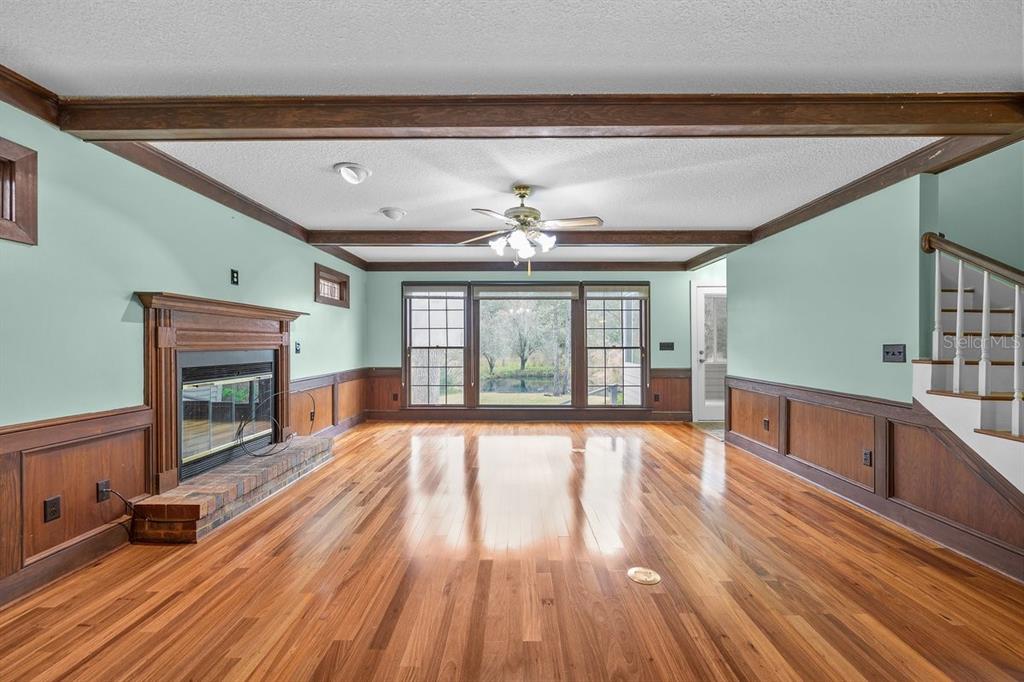 2545 Crooked Creek Point Road Middleburg, FL 32068 - Photo 14 of 54 a view of an empty room with wooden floor and a window