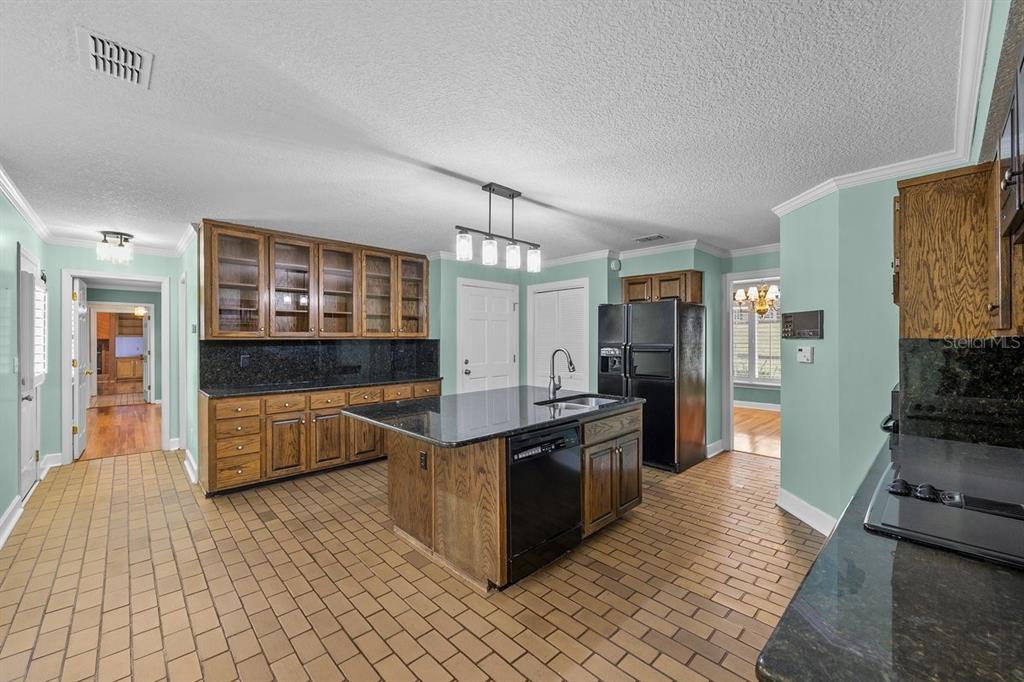 2545 Crooked Creek Point Road Middleburg, FL 32068 - Photo 17 of 54 a large kitchen with stainless steel appliances kitchen island granite countertop a refrigerator and a stove top oven