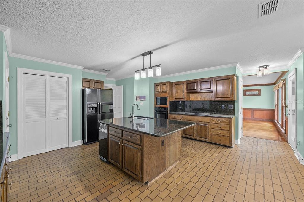 2545 Crooked Creek Point Road Middleburg, FL 32068 - Photo 18 of 54 a kitchen with stainless steel appliances granite countertop a refrigerator and a stove top oven