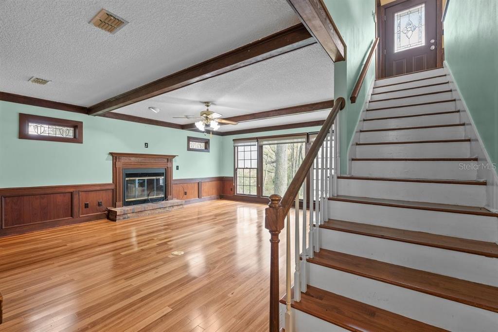 2545 Crooked Creek Point Road Middleburg, FL 32068 - Photo 36 of 54 a view of a livingroom with wooden floor and stairs