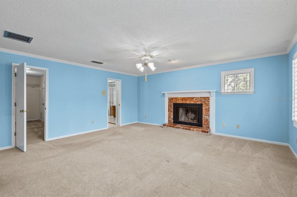 2545 Crooked Creek Point Road Middleburg, FL 32068 - Photo 46 of 54 a view of a livingroom with a fireplace and a chandelier fan
