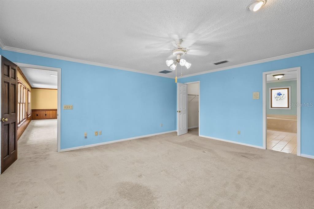 2545 Crooked Creek Point Road Middleburg, FL 32068 - Photo 48 of 54 an empty room with chandelier fan and windows