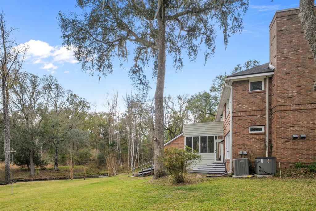 2545 Crooked Creek Point Road Middleburg, FL 32068 - Photo 5 of 54 a front view of a house with garden