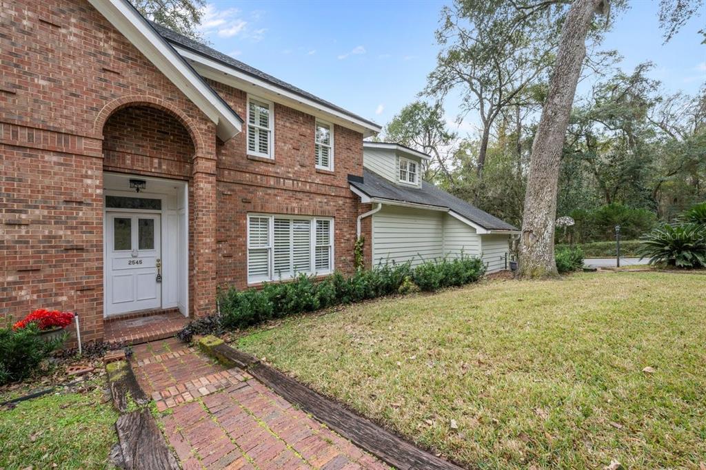 2545 Crooked Creek Point Road Middleburg, FL 32068 - Photo 8 of 54 a front view of a house with garden