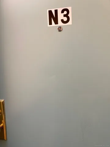 a kitchen with stainless steel appliances granite countertop a stove a refrigerator and a sink with wooden cabinets