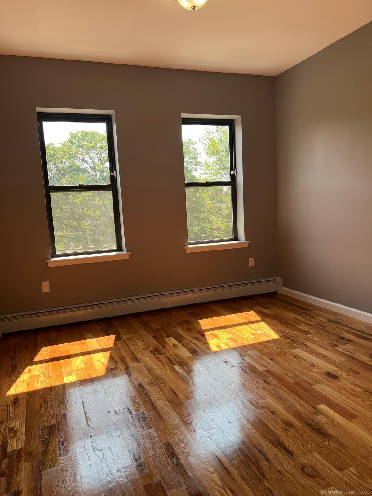 79 Barbour Street, Unit N3 Hartford, CT 06120 - Photo 4 of 7 a view of a room with wooden floor and a window