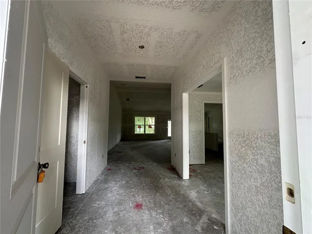 a view of a hallway with wooden shelves