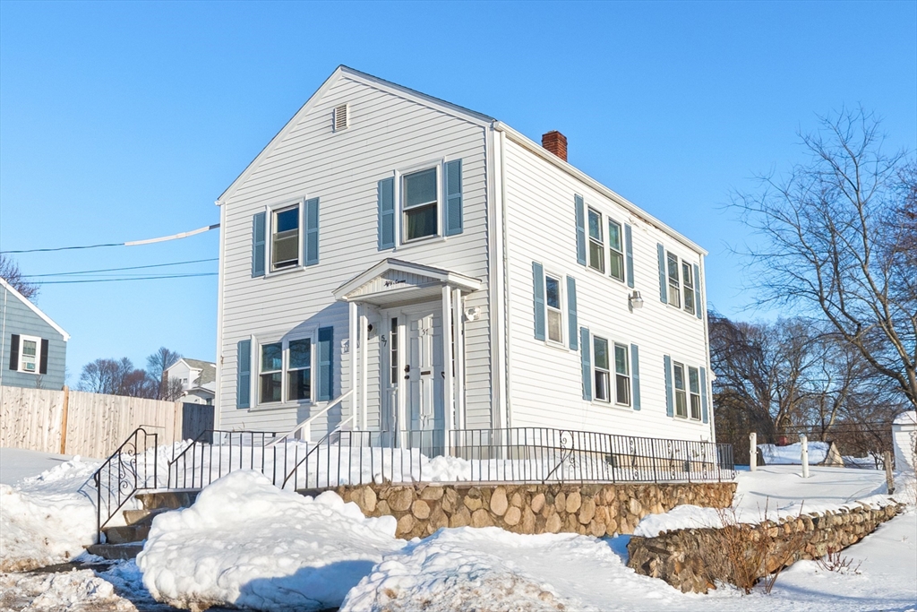 a front view of a house with a bench