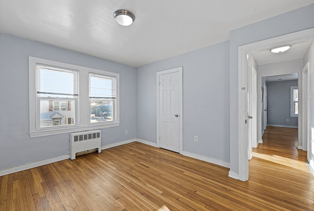 57-59 Larchwood Road, Unit 1 Methuen, MA 01844 - Photo 3 of 16 an empty room with wooden floor and windows