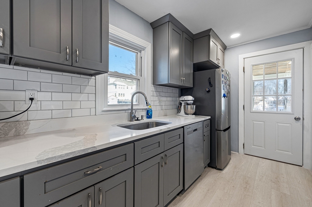 57-59 Larchwood Road, Unit 1 Methuen, MA 01844 - Photo 7 of 16 a kitchen with stainless steel appliances granite countertop a sink a refrigerator and cabinets