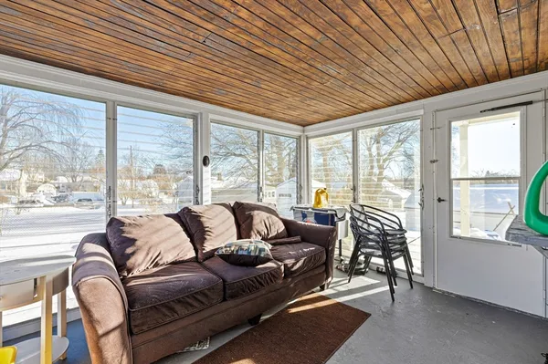 a living room with furniture and floor to ceiling windows
