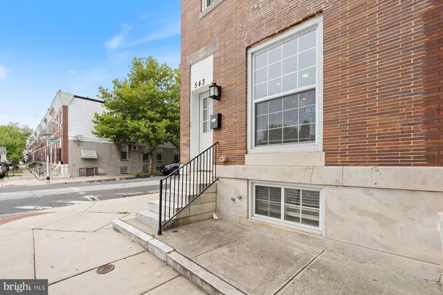 a view of a building with car parked