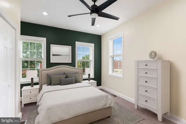 an empty room with windows and closet