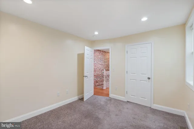 a view of a livingroom with a ceiling fan and window