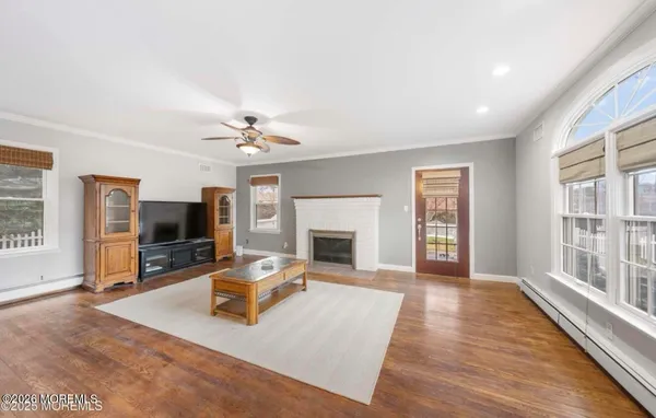 a living room with furniture fireplace and flat screen tv