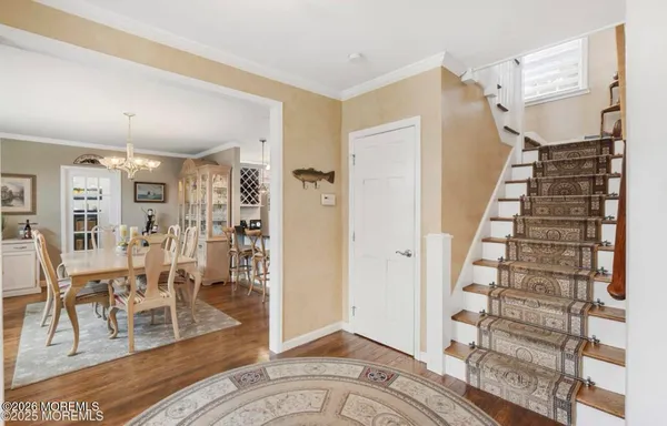 a view of a livingroom with wooden floor and stairs