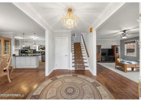 a view of entryway with kitchen and living room