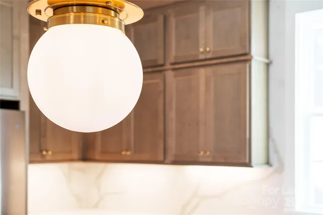 a kitchen with stainless steel appliances granite countertop a sink a stove and a wooden floors