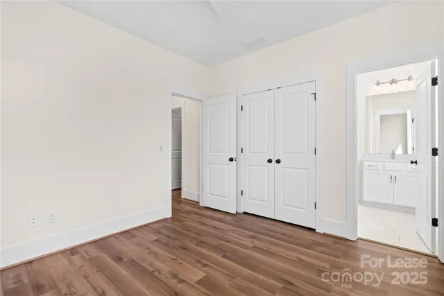 a view of a room with wooden floor