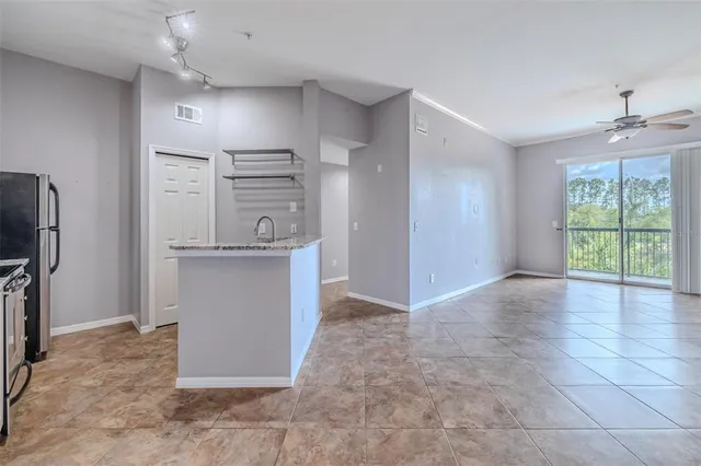 a view of a kitchen with refrigerator and windows