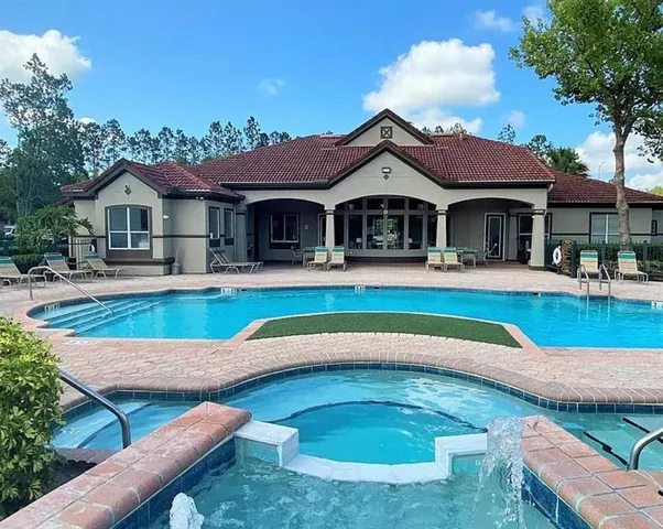 a swimming pool with outdoor seating and yard