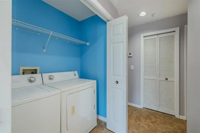 a view of storage and utility room with washer and dryer
