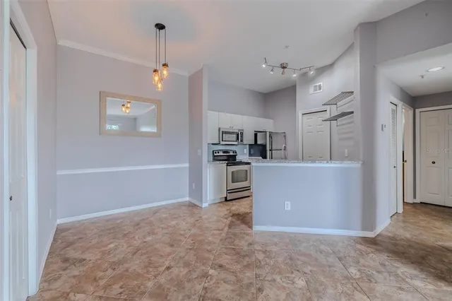 a view of a kitchen and refrigerator