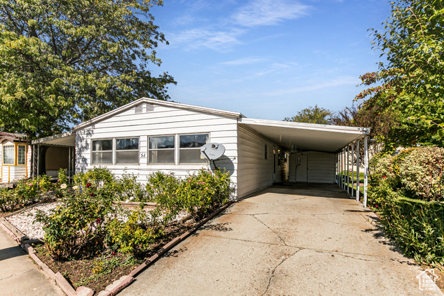 1111 North 2000 West, Unit 52 Farr West, UT 84404 - Photo 1 of 1 Manufactured / mobile home featuring driveway and an attached carport