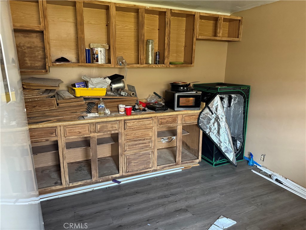 343 West 84th Street Los Angeles, CA 90003 - Photo 6 of 15 a kitchen with stainless steel appliances granite countertop a stove and a sink