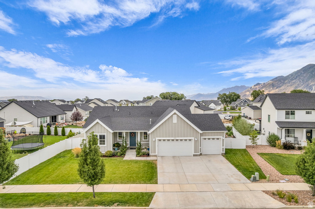 2454 West Jackson Street Mapleton, UT 84664 - Photo 61 of 63 View of front of house featuring board and batten siding, a residential view, a garage, a shingled roof, and driveway