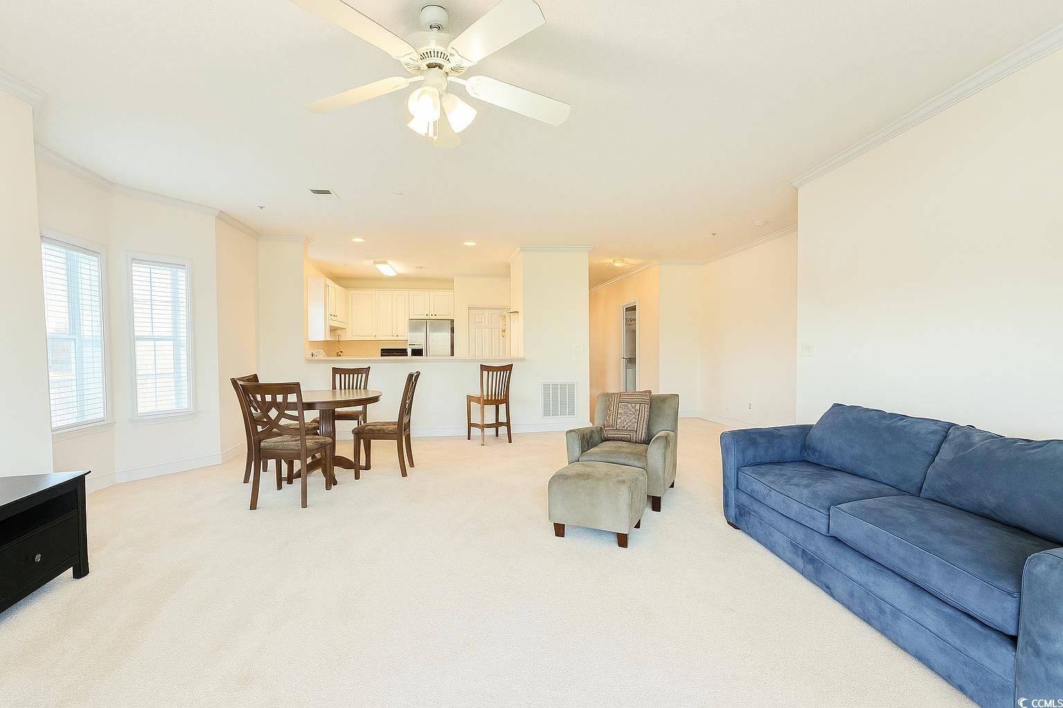 1100 Commons Boulevard, Unit 508 Myrtle Beach, SC 29572 - Photo 11 of 24 Living room featuring ornamental molding, light carpet, and ceiling fan