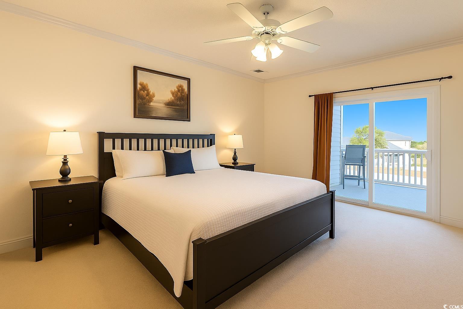1100 Commons Boulevard, Unit 508 Myrtle Beach, SC 29572 - Photo 12 of 24 Primary Bedroom with ornamental molding, light colored carpet, access to outside, and a ceiling fan.