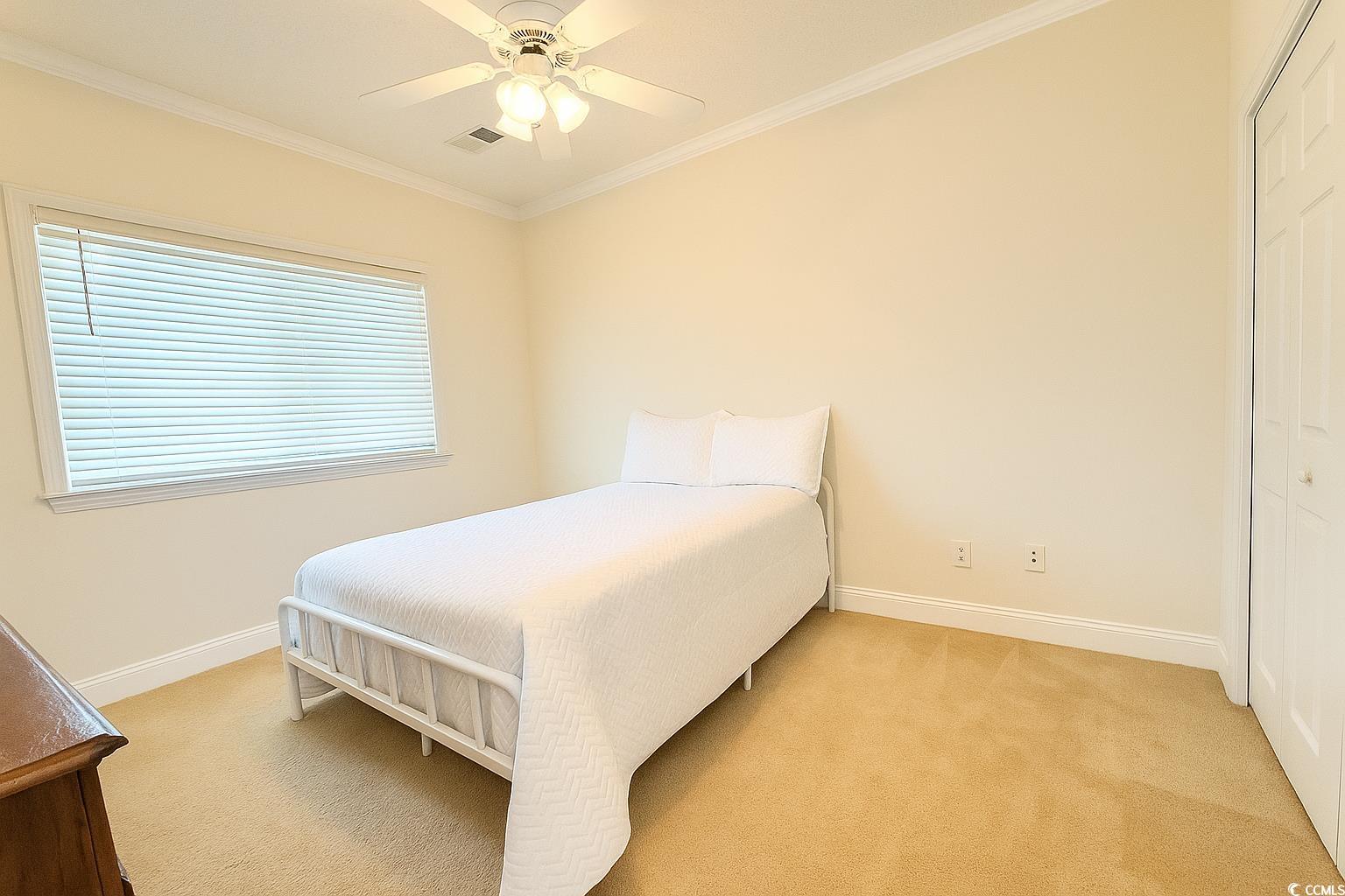 1100 Commons Boulevard, Unit 508 Myrtle Beach, SC 29572 - Photo 16 of 24 Carpeted 3rd bedroom featuring a dresser, ceiling fan, and a closet.