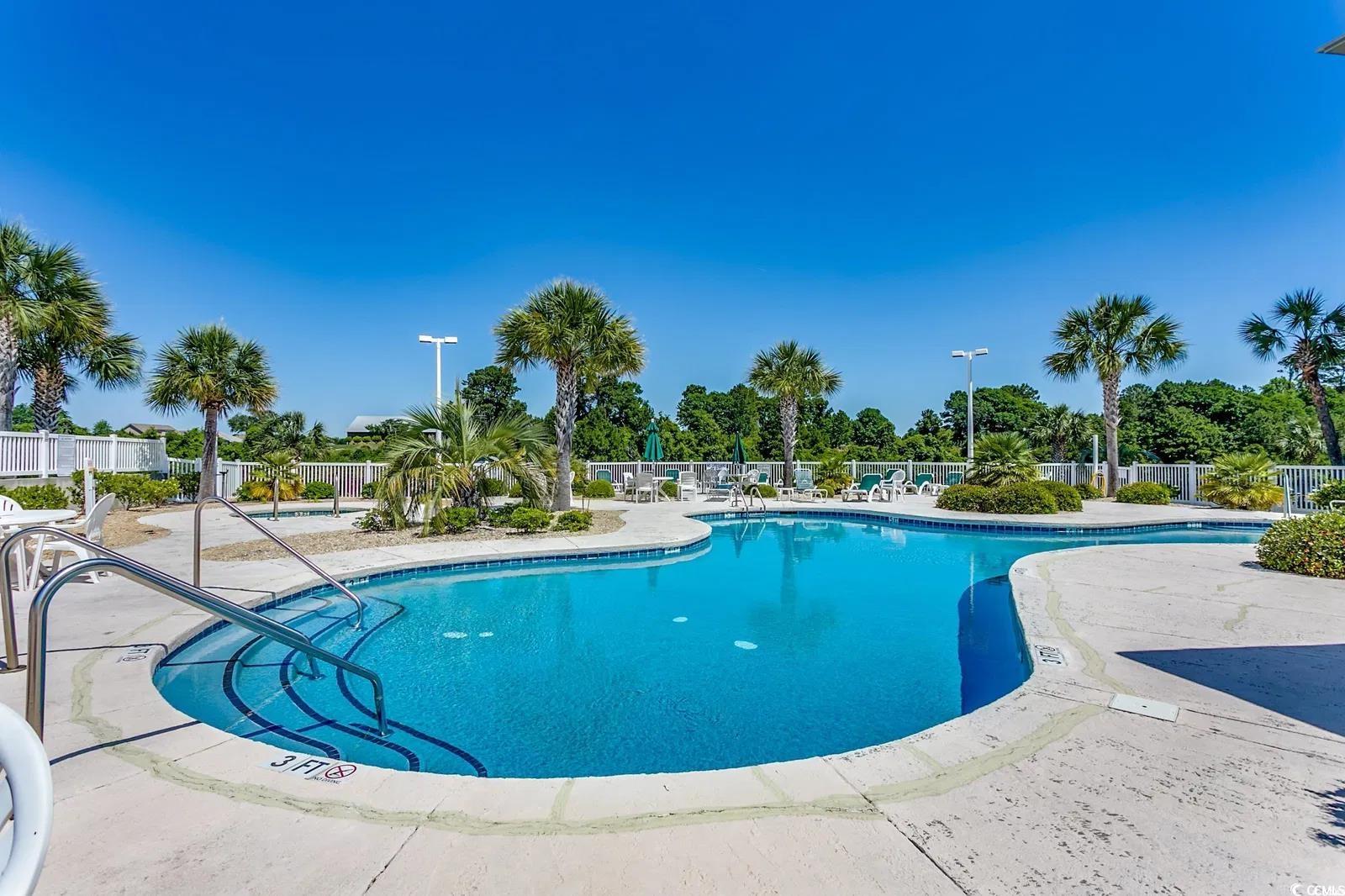 1100 Commons Boulevard, Unit 508 Myrtle Beach, SC 29572 - Photo 5 of 24 Community pool with a patio area