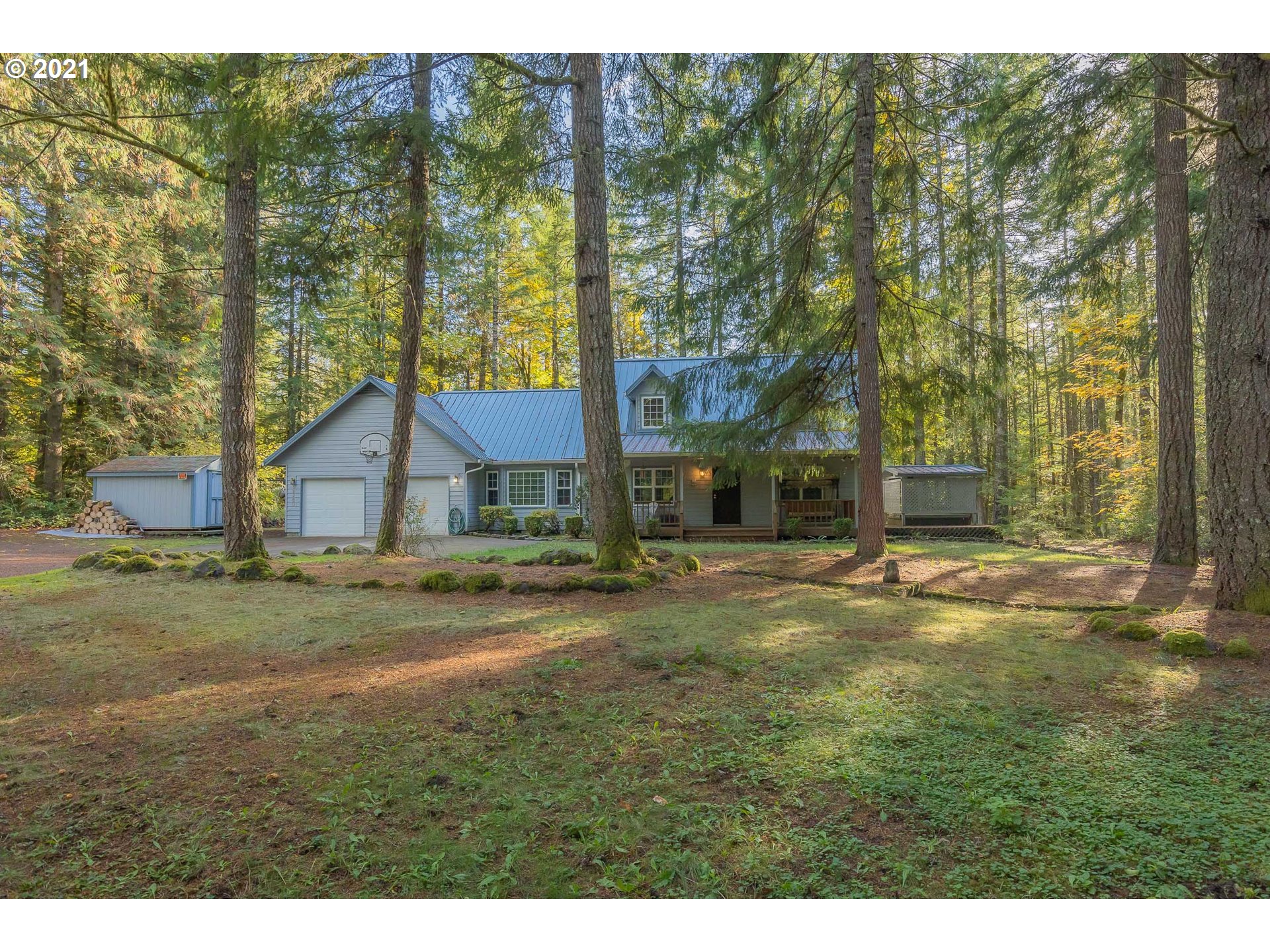 69280 East Barlow Trail Road Rhododendron, OR 97049 - Photo 1 of 25 a backyard of a house with a garden and outdoor seating
