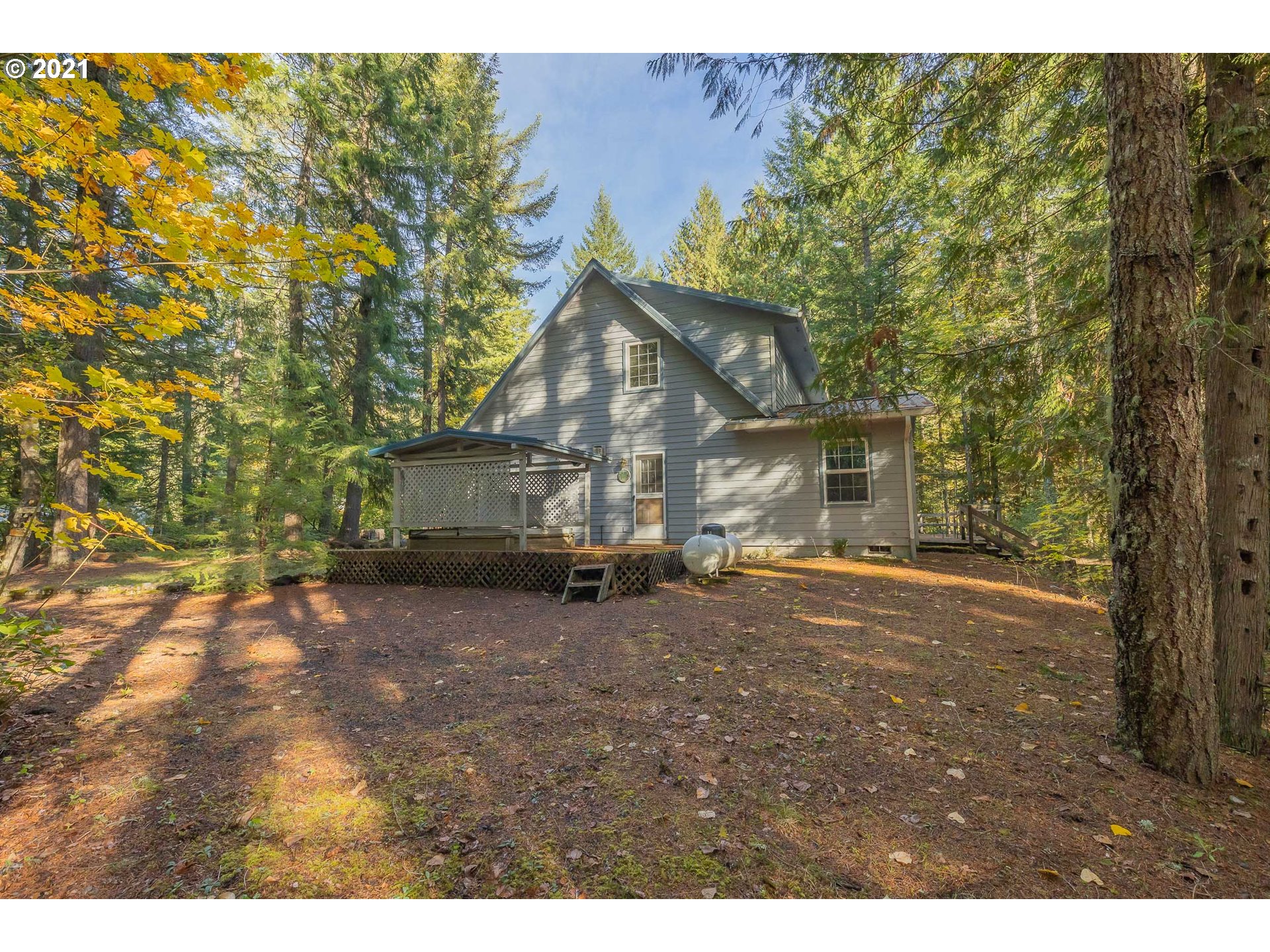 69280 East Barlow Trail Road Rhododendron, OR 97049 - Photo 9 of 25 a view of a house with a tree in the background